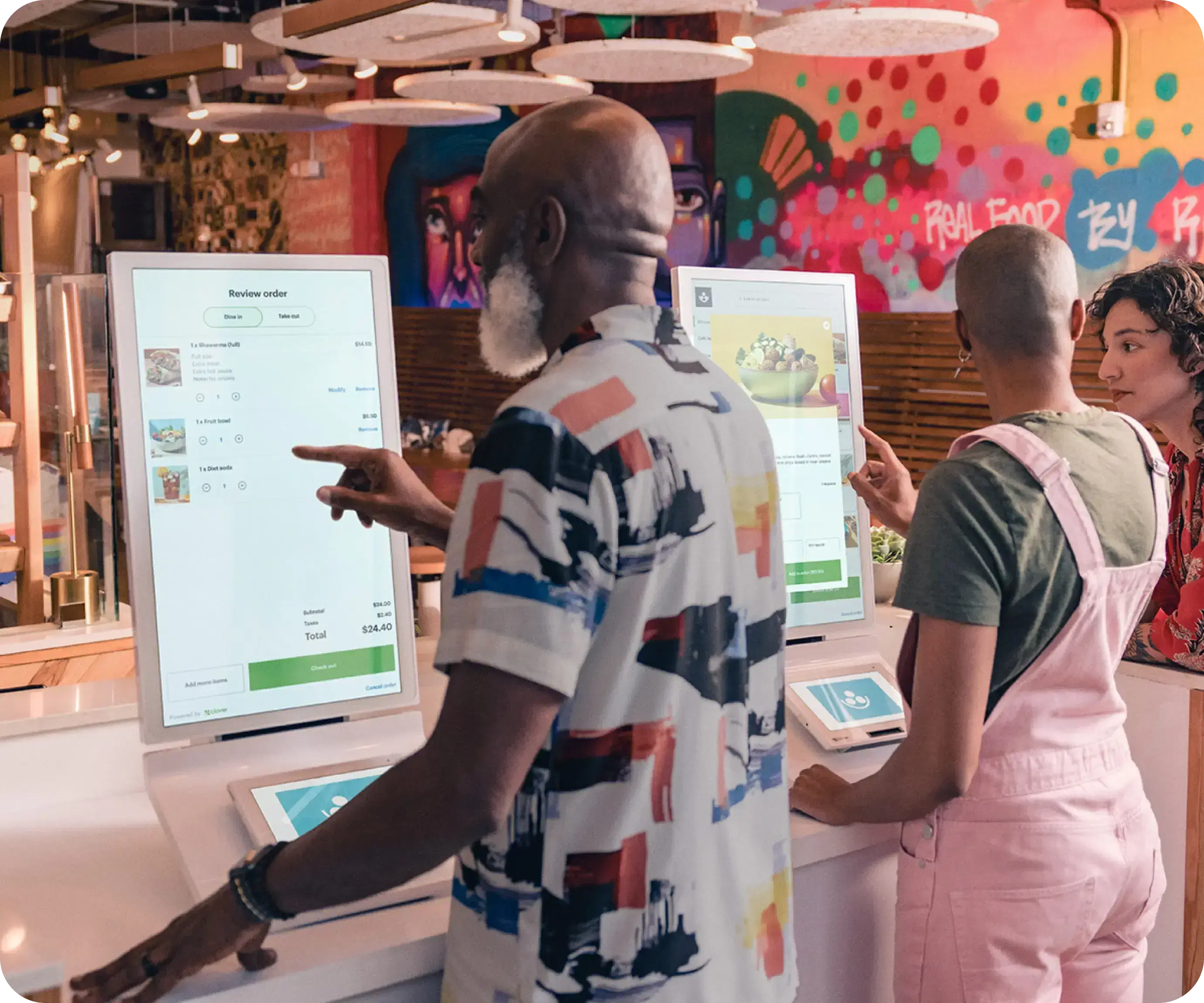 Two people using the kiosk device